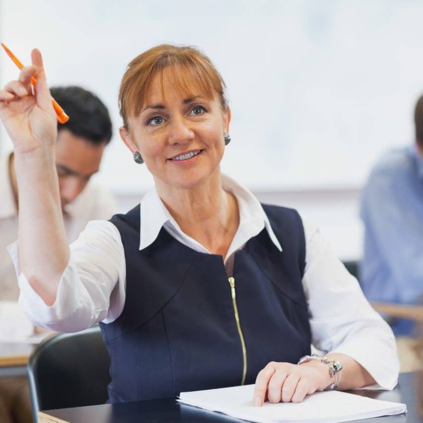 Female mature student raising her hand